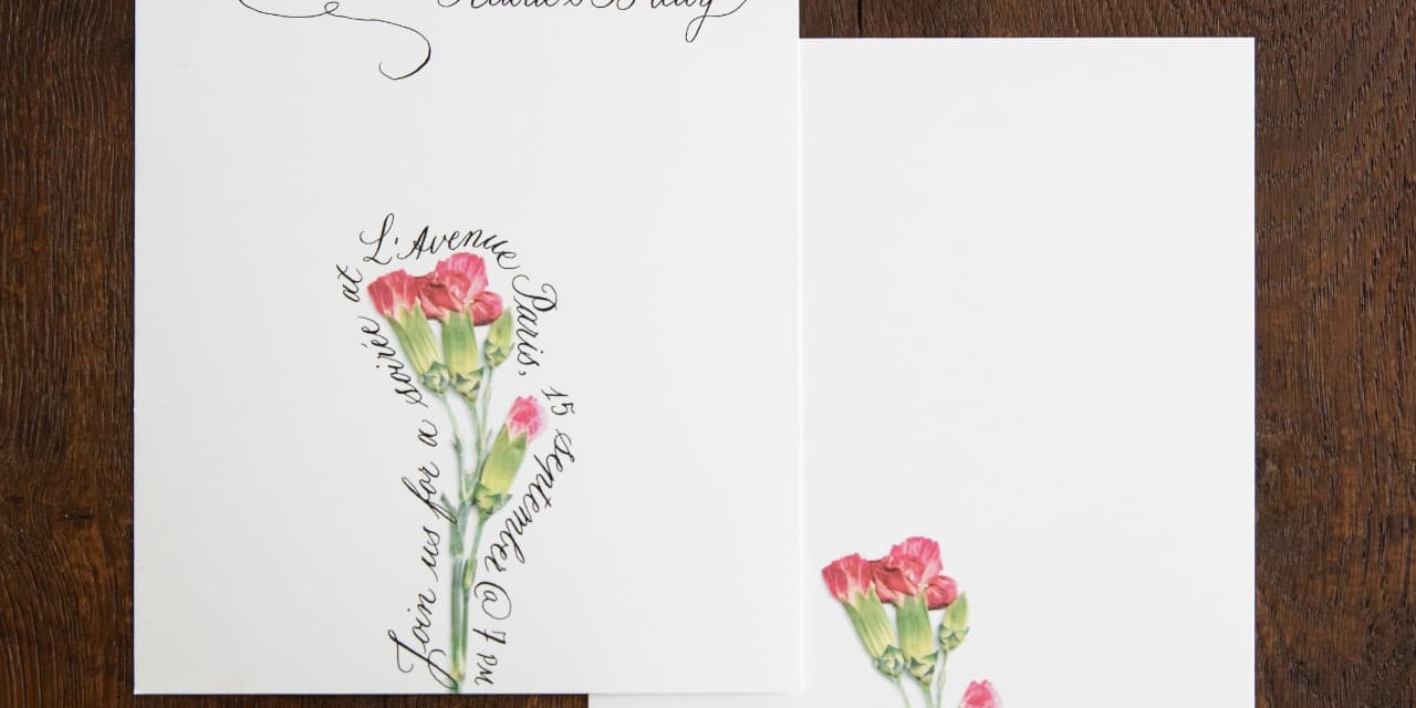 Bespoke Pétalia invitation cards with pressed pink carnations and copperplate calligraphy